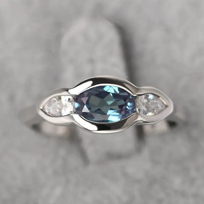 Geometric ellipse zircon ring in white gold finish on a copper band.