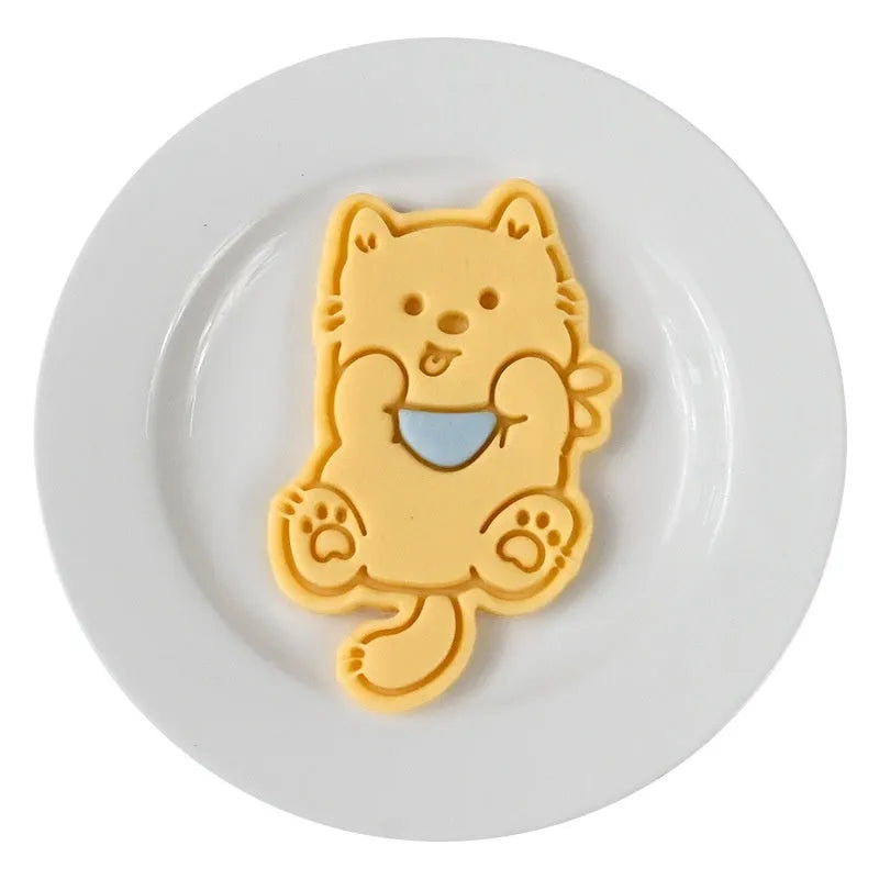 Three dimensional plastic press mould for creating puppy cartoon biscuits and cake decorations.