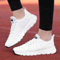 Women's running shoes in black, pink, or white with a fly weave upper and durable outsole.