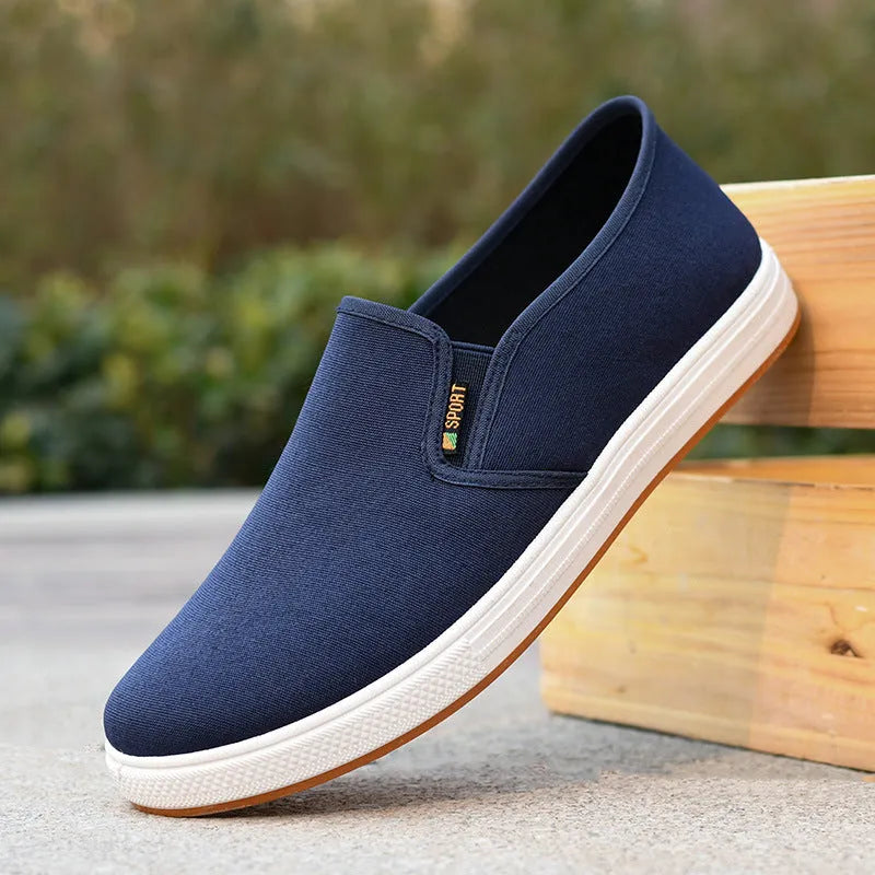 Men's black and blue slip-on canvas trainers with round toe and shallow mouth design