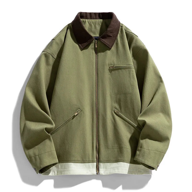 Man wearing a mint green loose-fit retro jacket with dark contrast lapels and side seam pockets.