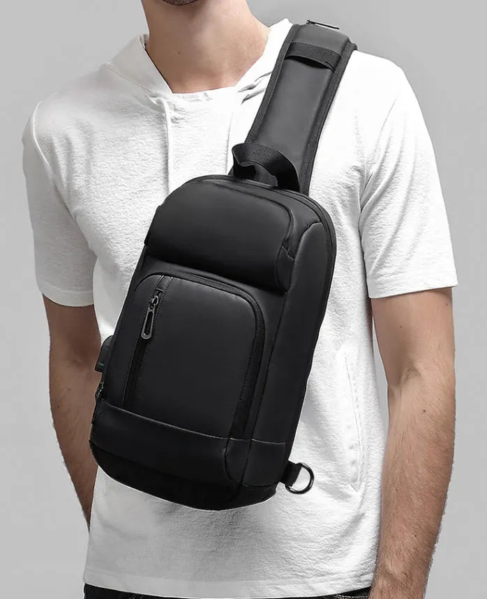 Black medium-sized PVC outdoor shoulder bag showing front view and interior laptop compartment.