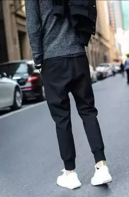 Black casual sports trousers with straight leg and tether closure, front view