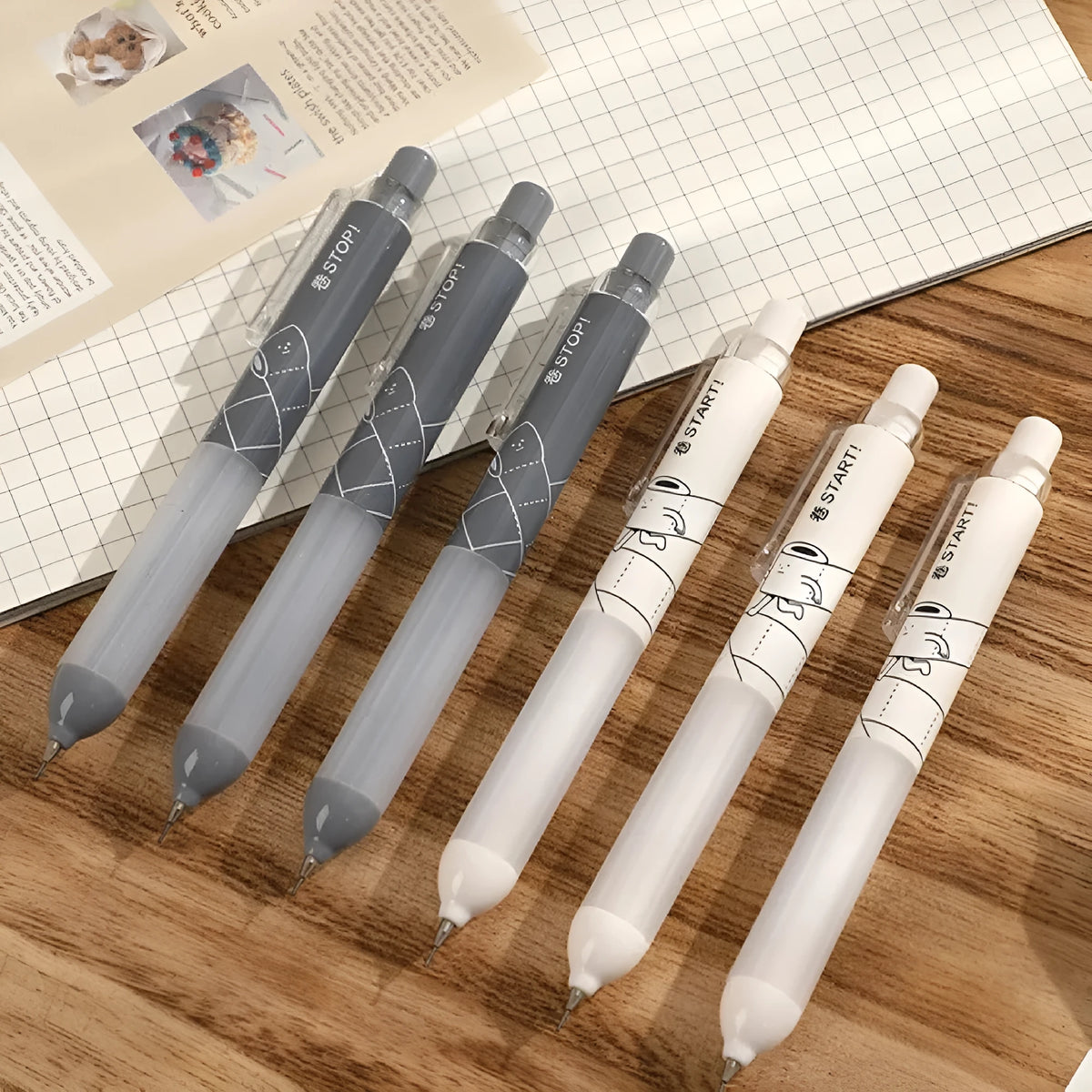 Black and white 0.5mm mechanical pencils with cloud grip on a minimalist background.