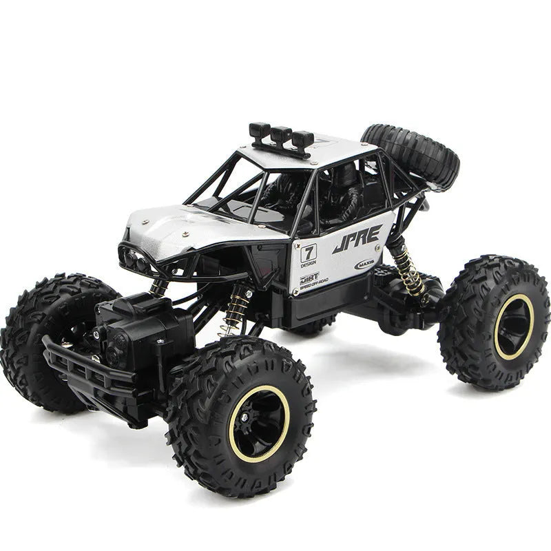 Black and silver 2.4G wireless remote control four-wheel drive car on a rough surface.