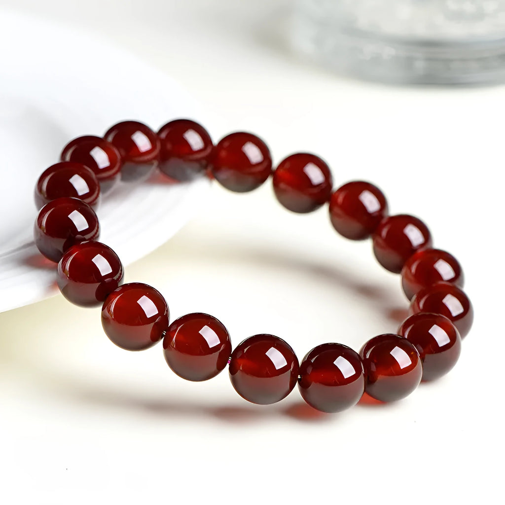 Crystal bracelet with natural orange red garnet beads and traditional Chinese ruyi charm in retro unisex design