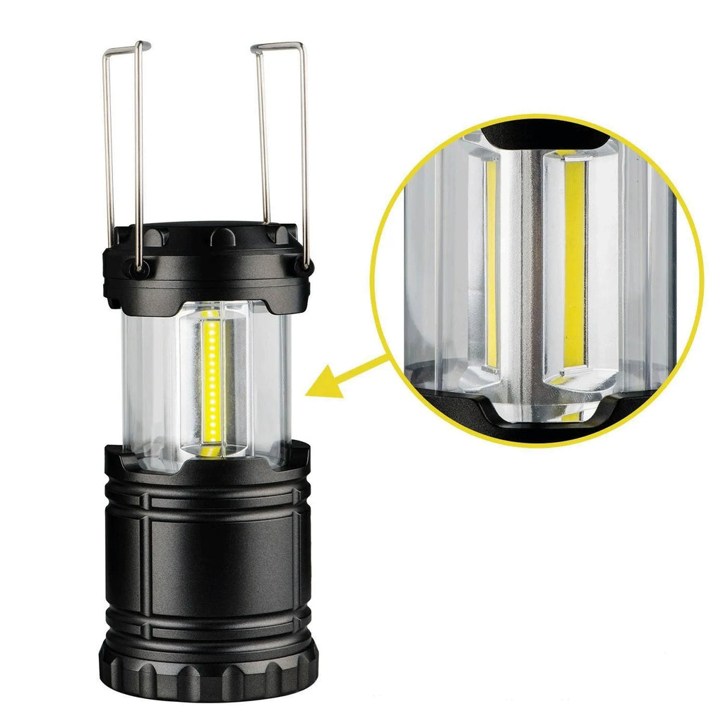 Gold multifunctional COB camping lantern with solar panel, telescopic design, and hook on a wooden table