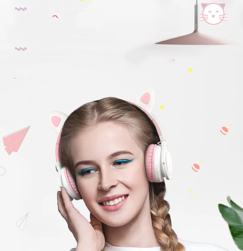 Pink and white Luminous wireless Bluetooth gaming headset with over-ear earcups and a braided cable.