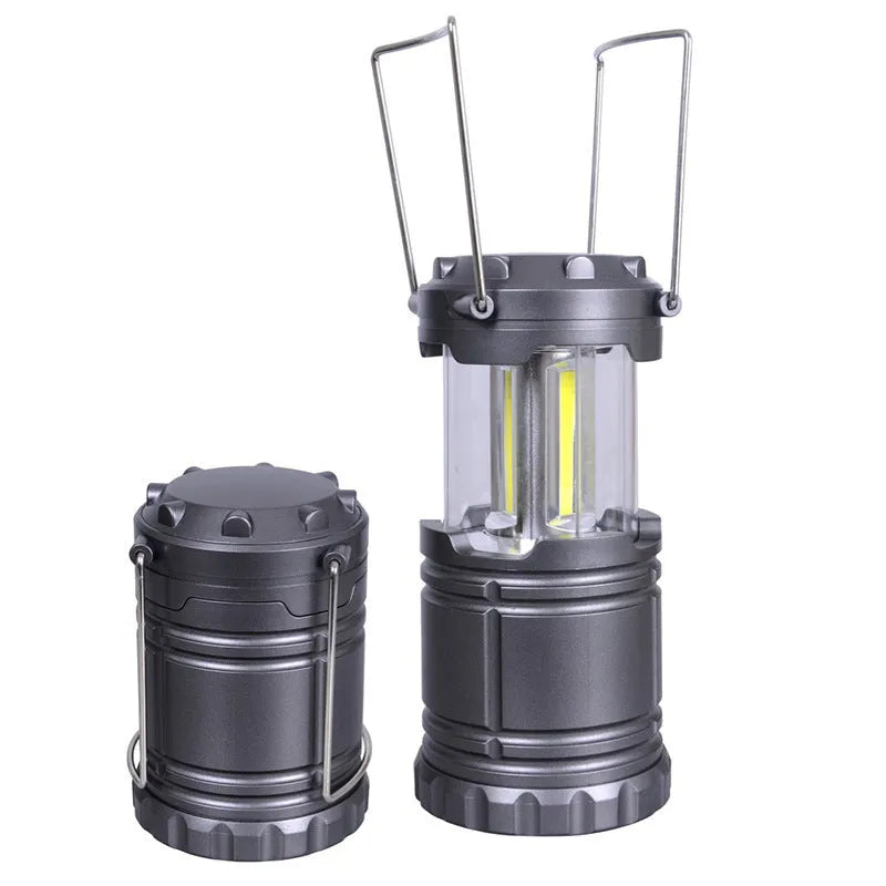 Gold multifunctional COB camping lantern with solar panel, telescopic design, and hook on a wooden table