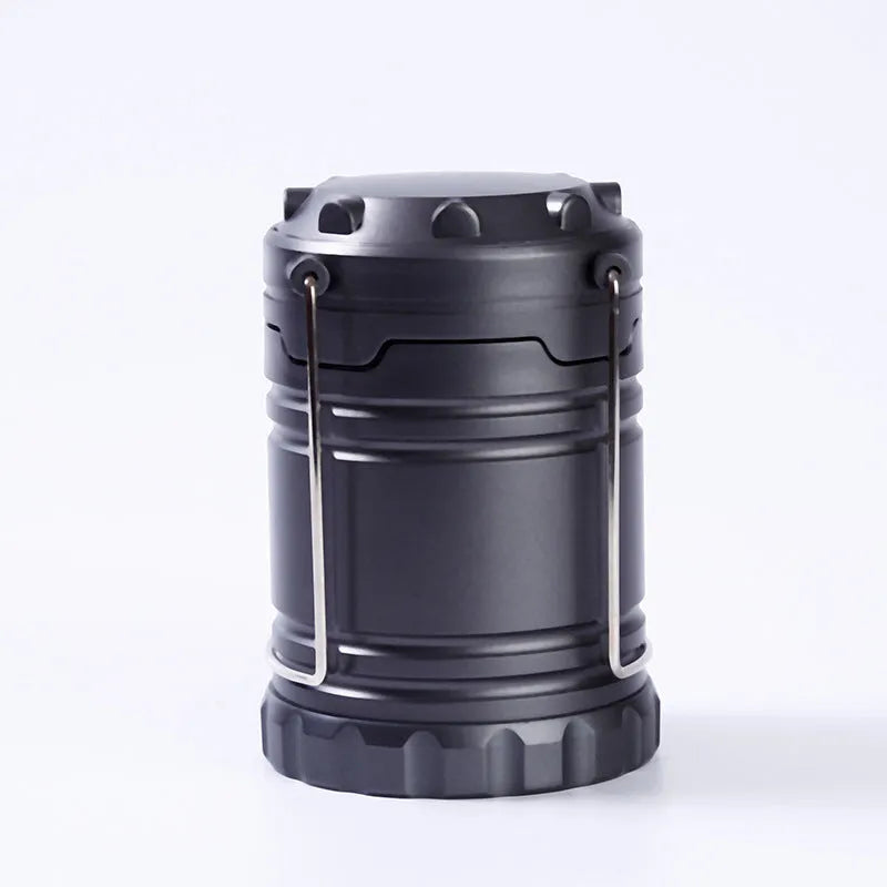 Gold multifunctional COB camping lantern with solar panel, telescopic design, and hook on a wooden table