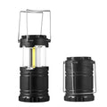 Gold multifunctional COB camping lantern with solar panel, telescopic design, and hook on a wooden table