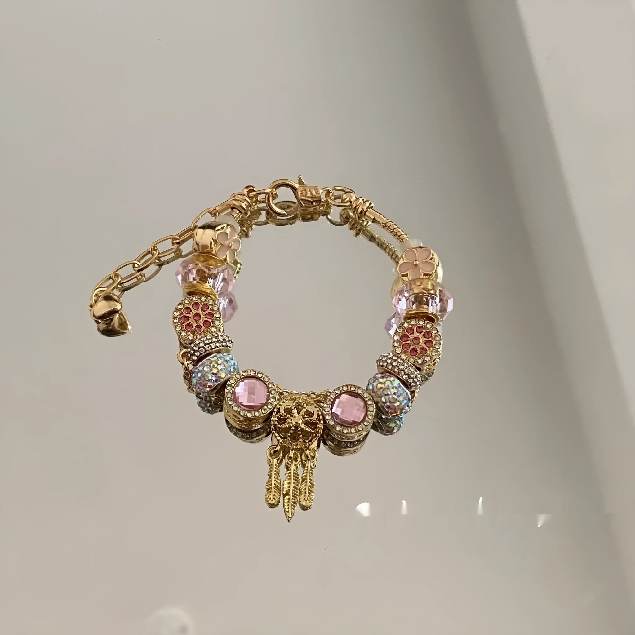 Women's dream catcher star bracelet with colourful crystals and electroplated finish on a white background