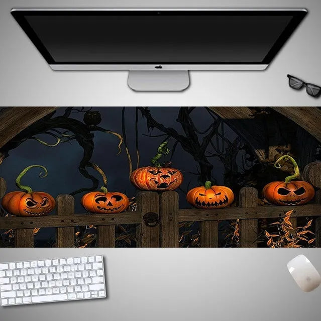 Oversized Halloween-themed computer mouse pad with non-slip rubber cloth backing on wooden desk