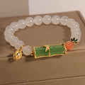 Close-up of a white agate and jade bamboo joint bracelet for women, traditional Chinese style.