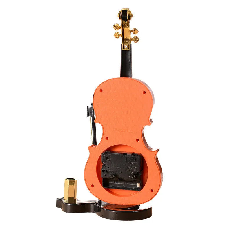 Brown violin pen inserted alarm clock with LED and pointer display on desk