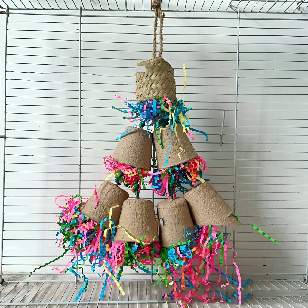 Wood-coloured woven palm fibre parrot chew toy shaped like a paper cup, hanging.