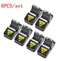 Six black snapping mousetraps with smooth plastic surface showing precise dimensions