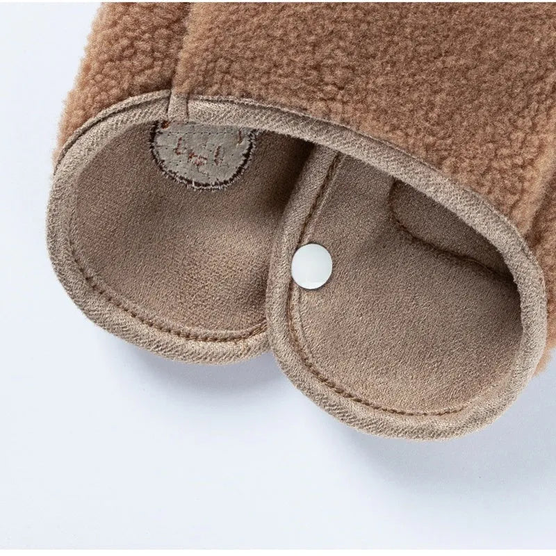 Brown fleece dog coat with bear embroidery and side-button closure on a small dog