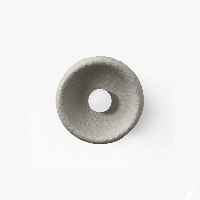 Japanese-style simple silent wall lamp with white resin shade in a modern room setting.