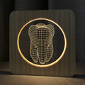 Wood-coloured acrylic night lamp in shape of a tooth, with USB cable.