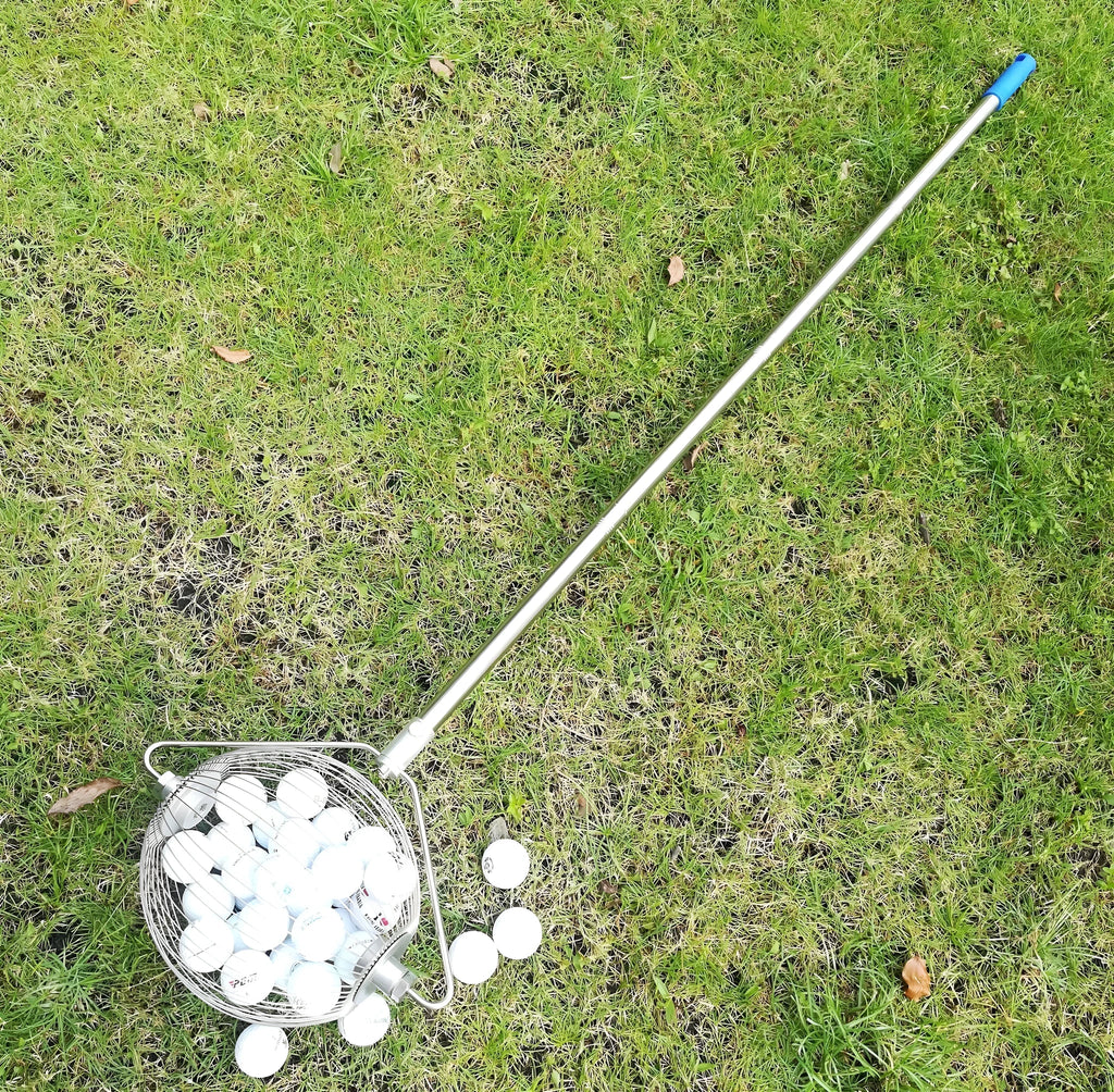 Metallic stainless steel golf ball picker tool on putting green