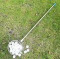 Metallic stainless steel golf ball picker tool on putting green