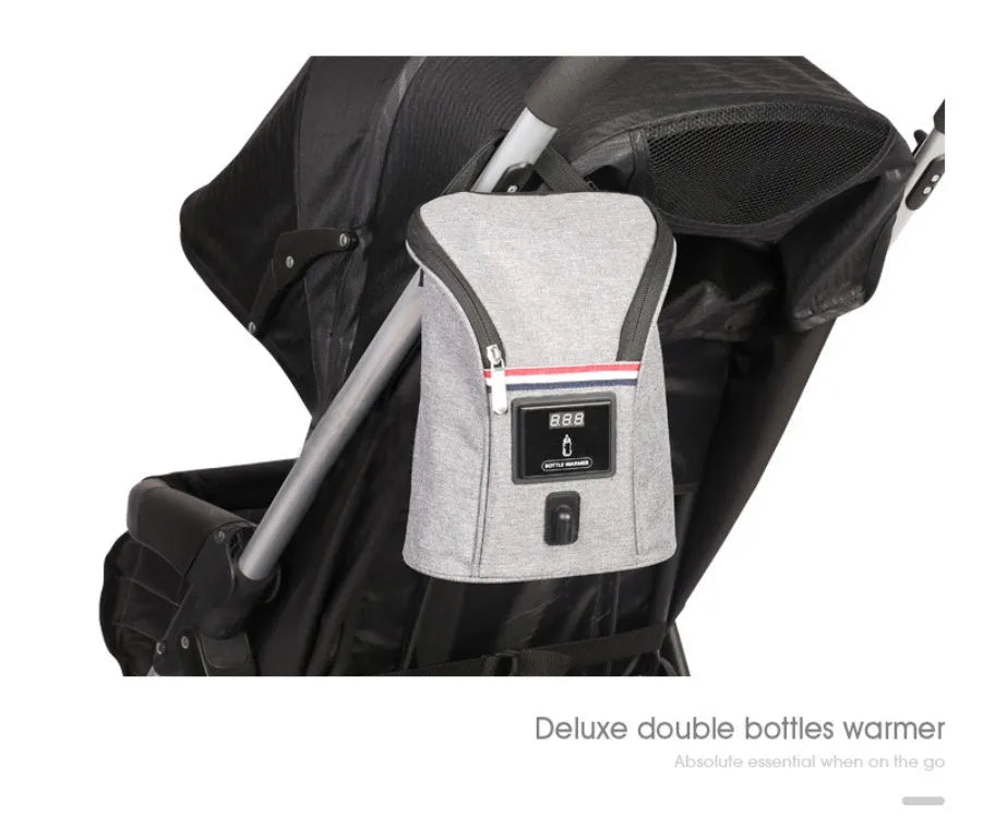 Grey Oxford cloth portable baby bottle warmer with carry handle and electronic display for car travel.
