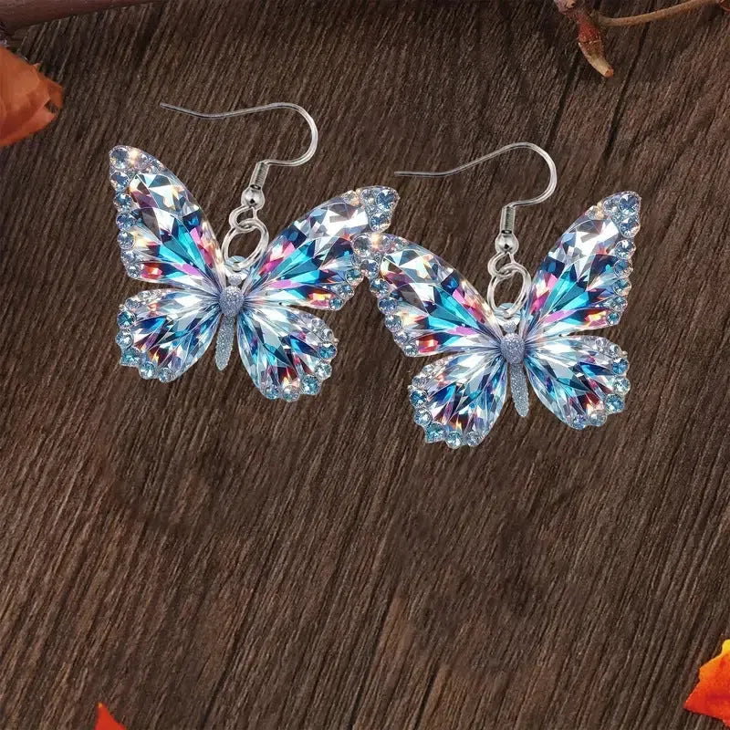 Colourful printed 2D acrylic earrings with butterfly design on a light background