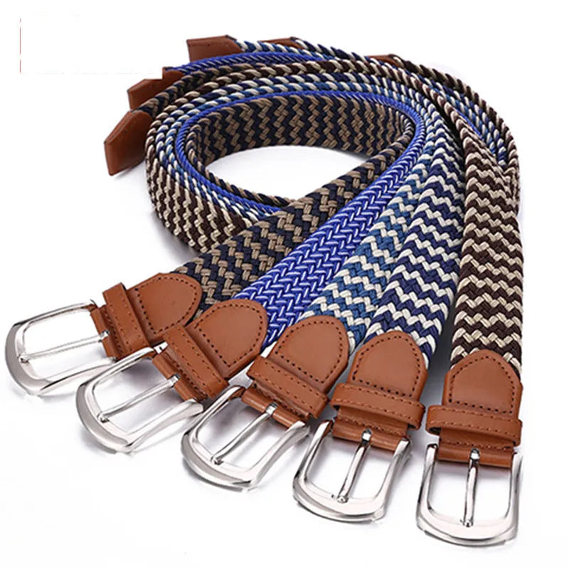 Unisex braided elasticated canvas belt in beige with alloy buckle, shown on a wooden surface
