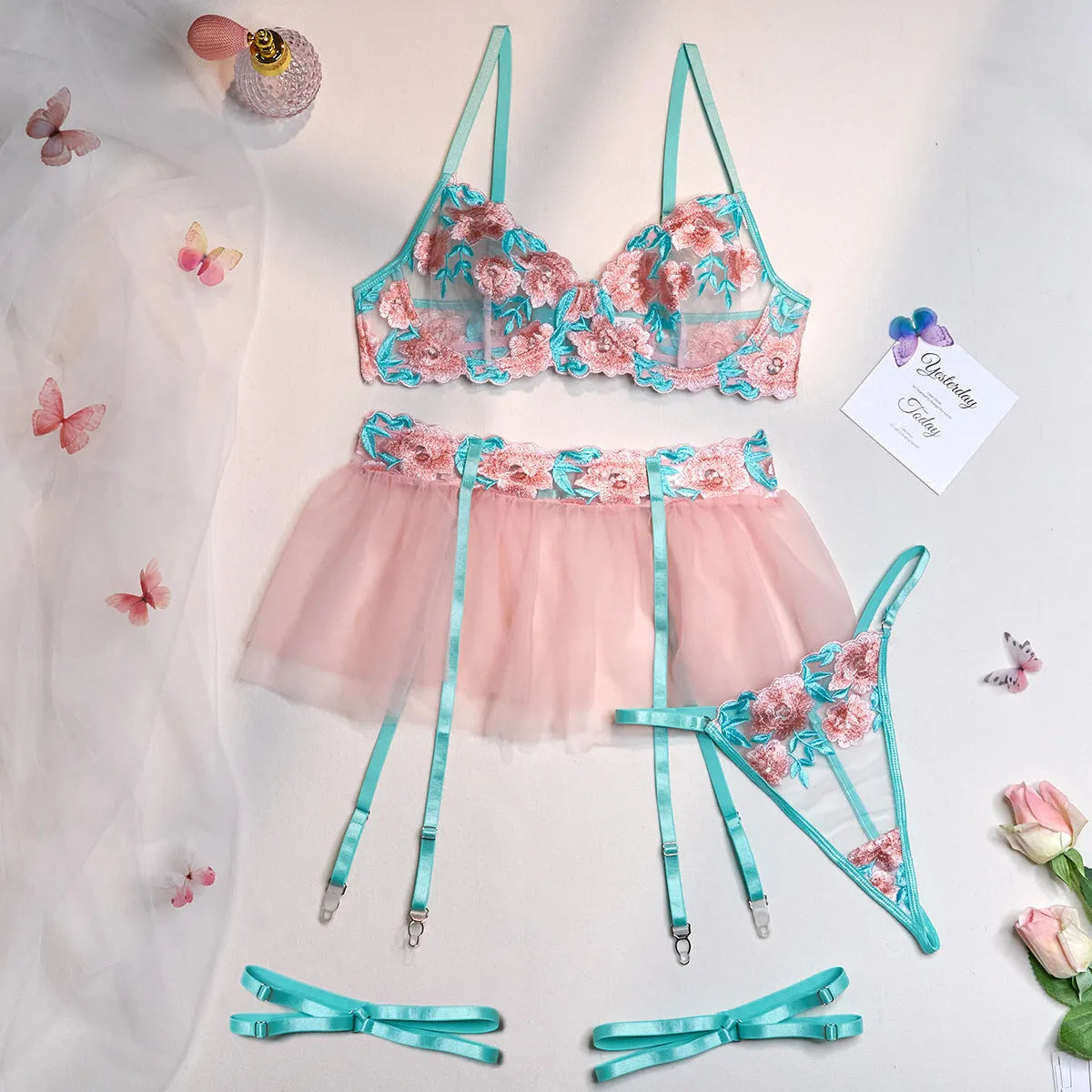 Women wearing pink embroidered mesh pettiskirt suit with matching top and skirt