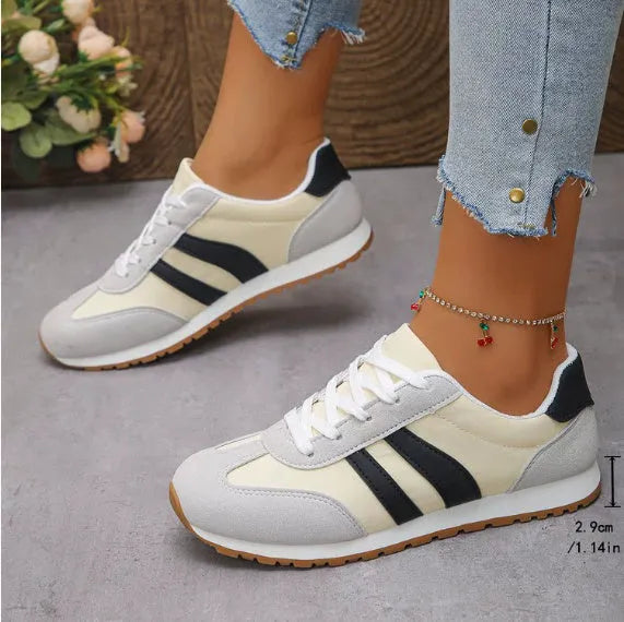 Blue and grey leisure sports shoes with Cortez stripes pattern, flat rubber sole, and round toe design