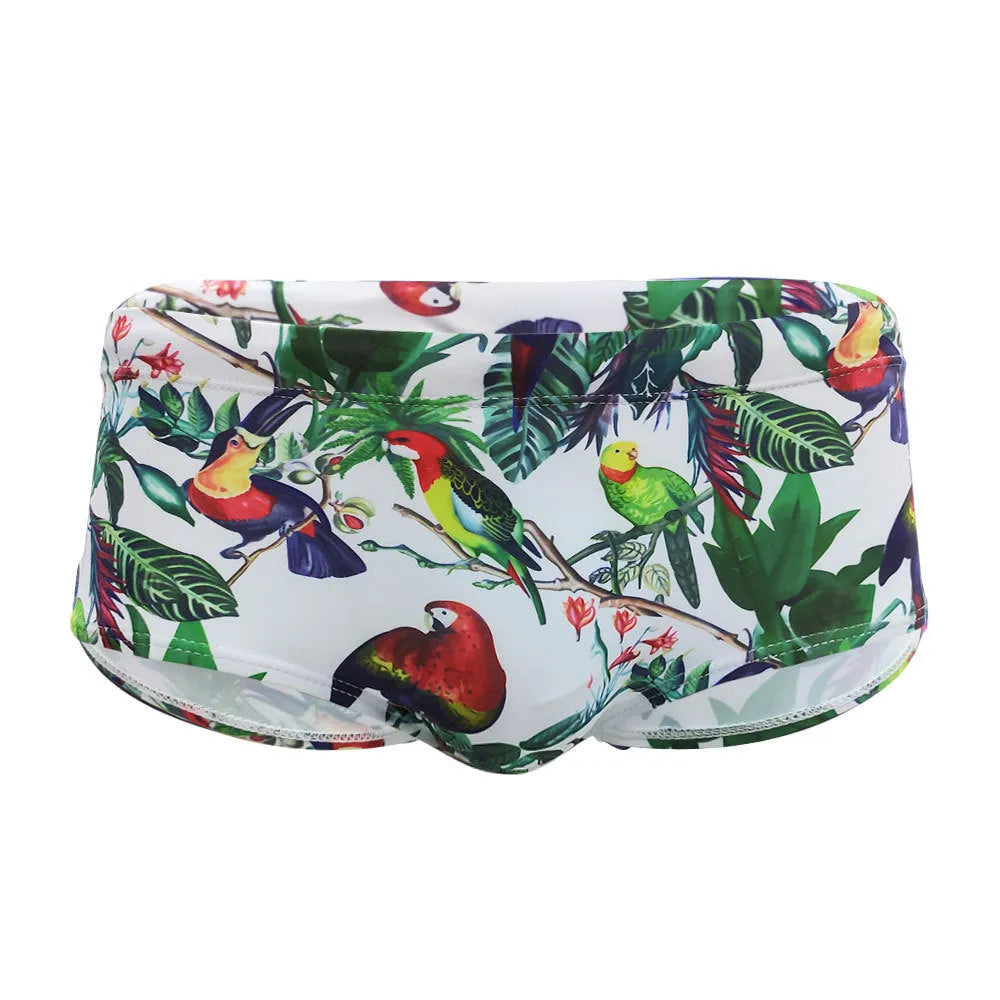 Men's navy blue swimming trunks with colourful flower and bird print pattern.
