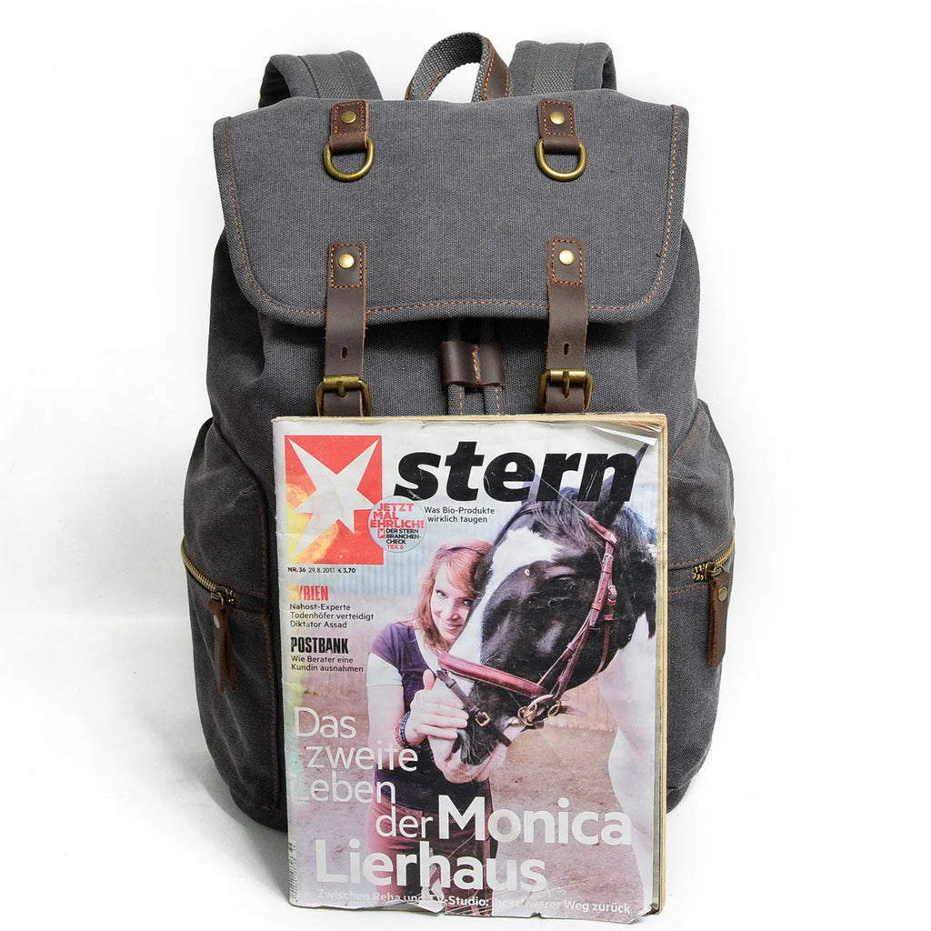 Canvas casual backpack with crazy horse leather trim in brown side view showing main compartment and shoulder strap