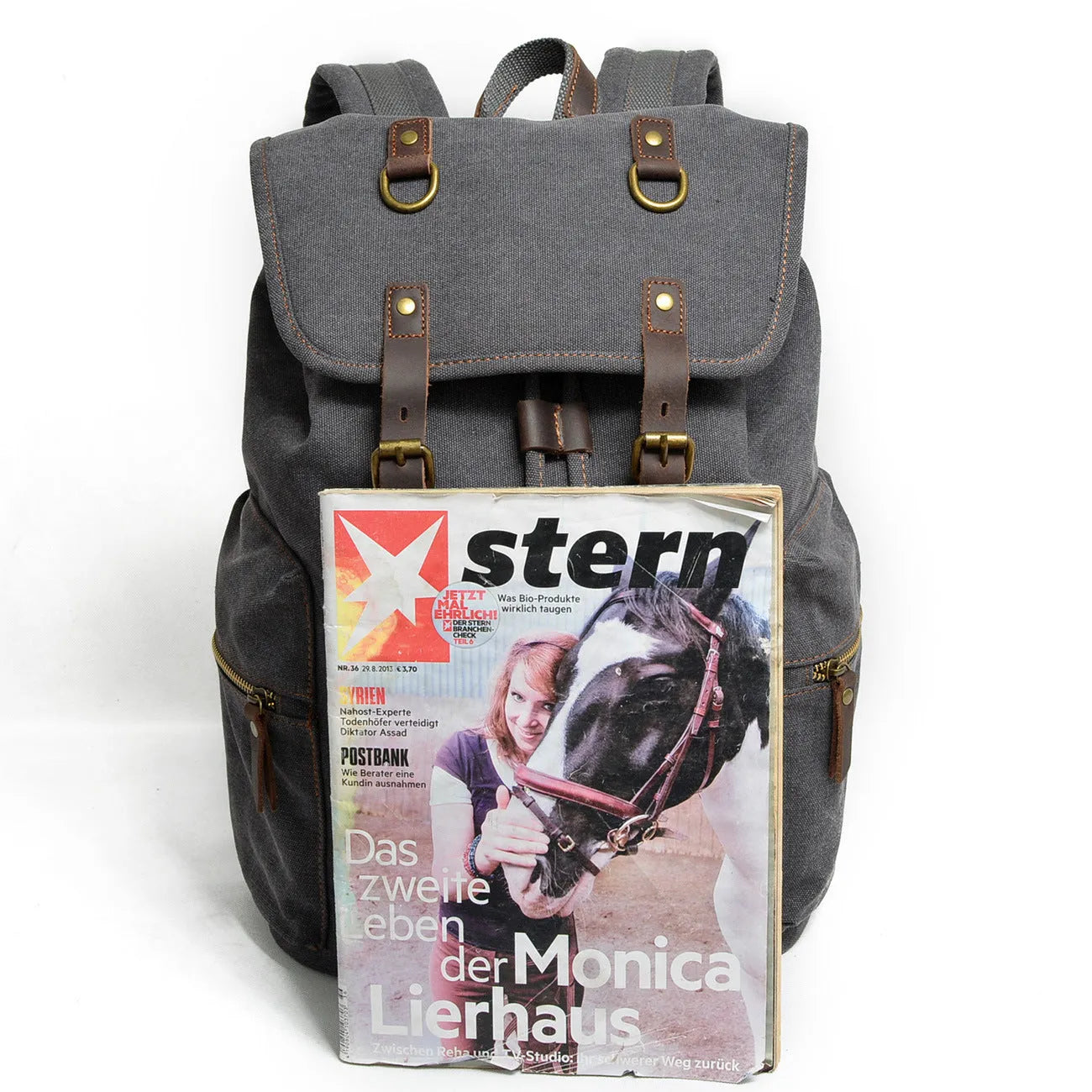 Canvas casual backpack with crazy horse leather trim in brown side view showing main compartment and shoulder strap