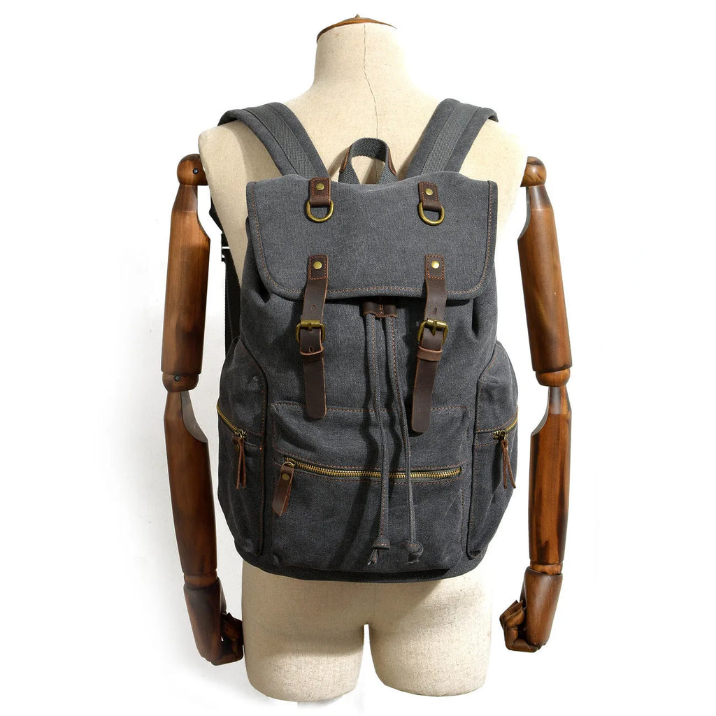 Canvas casual backpack with crazy horse leather trim in brown side view showing main compartment and shoulder strap