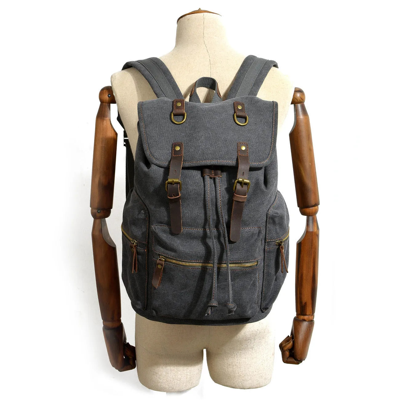 Canvas casual backpack with crazy horse leather trim in brown side view showing main compartment and shoulder strap