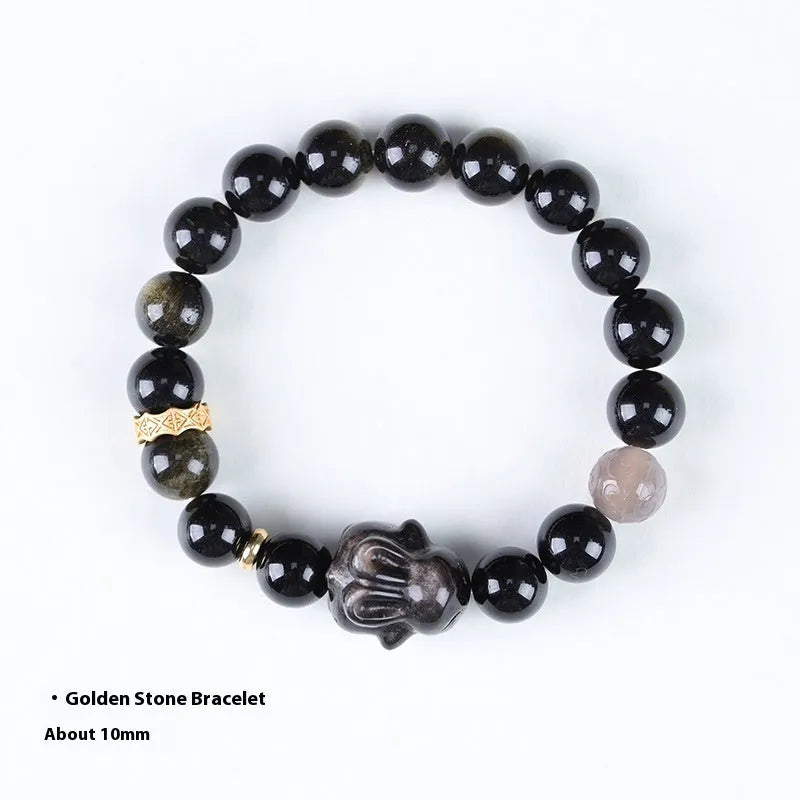 Handmade national style bracelet with a lying rabbit charm, grey agate, and metal details on a wrist.