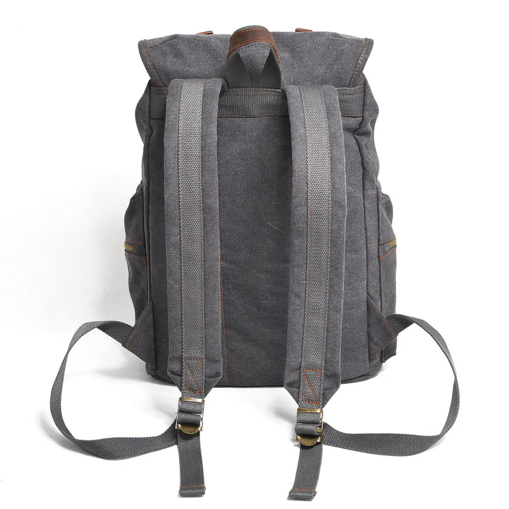 Canvas casual backpack with crazy horse leather trim in brown side view showing main compartment and shoulder strap