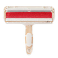 White plastic roller brush for pet hair removal on fabric surface