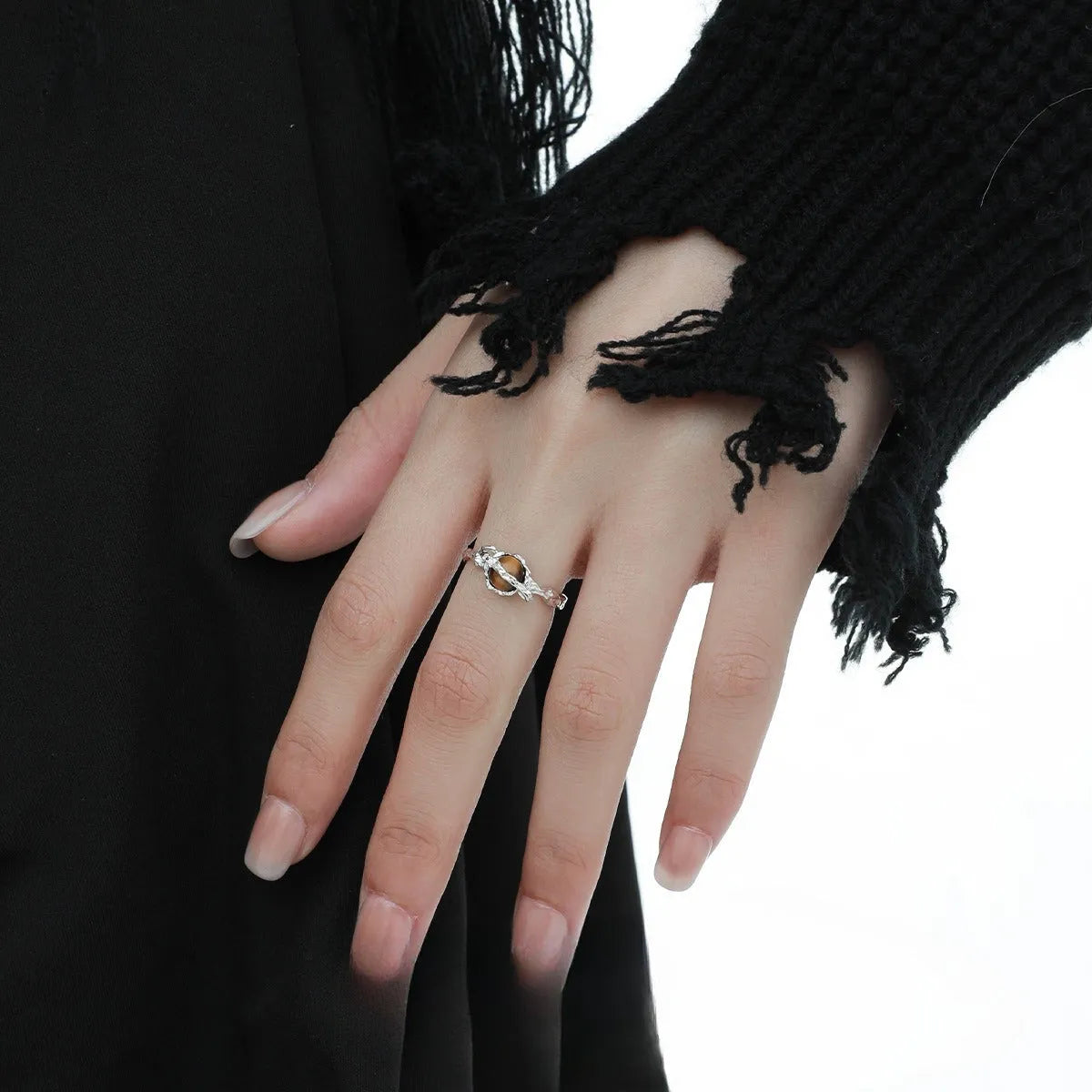 Women's adjustable Saturn design ring in silver with white gold electroplating.