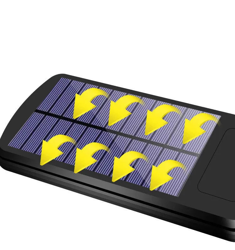 Black solar-powered outdoor security light with motion sensor mounted on a wall.