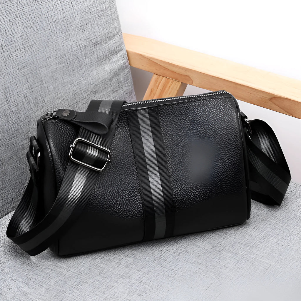 Black genuine leather one-shoulder crossbody bag showing its size and style.