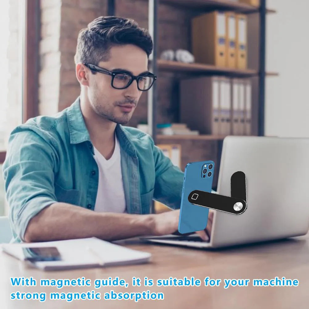Black aluminium magnetic phone holder mounted on side of laptop screen with smartphone attached.