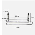 Silver stainless steel paper towel rack hanging on a kitchen cabinet door