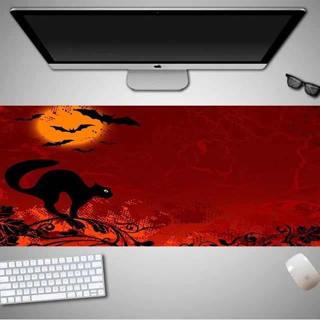 Oversized Halloween-themed computer mouse pad with non-slip rubber cloth backing on wooden desk