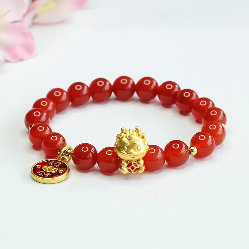 Close-up of a Chinese zodiac dragon bracelet with 8mm red agate beads on a wrist.