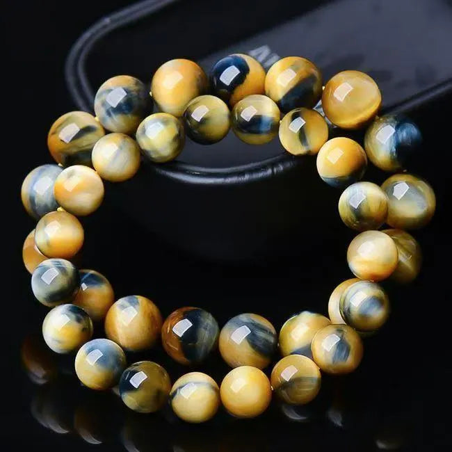 Handmade Fantasy Tigereye agate gemstone bracelet with round beads on a wrist.