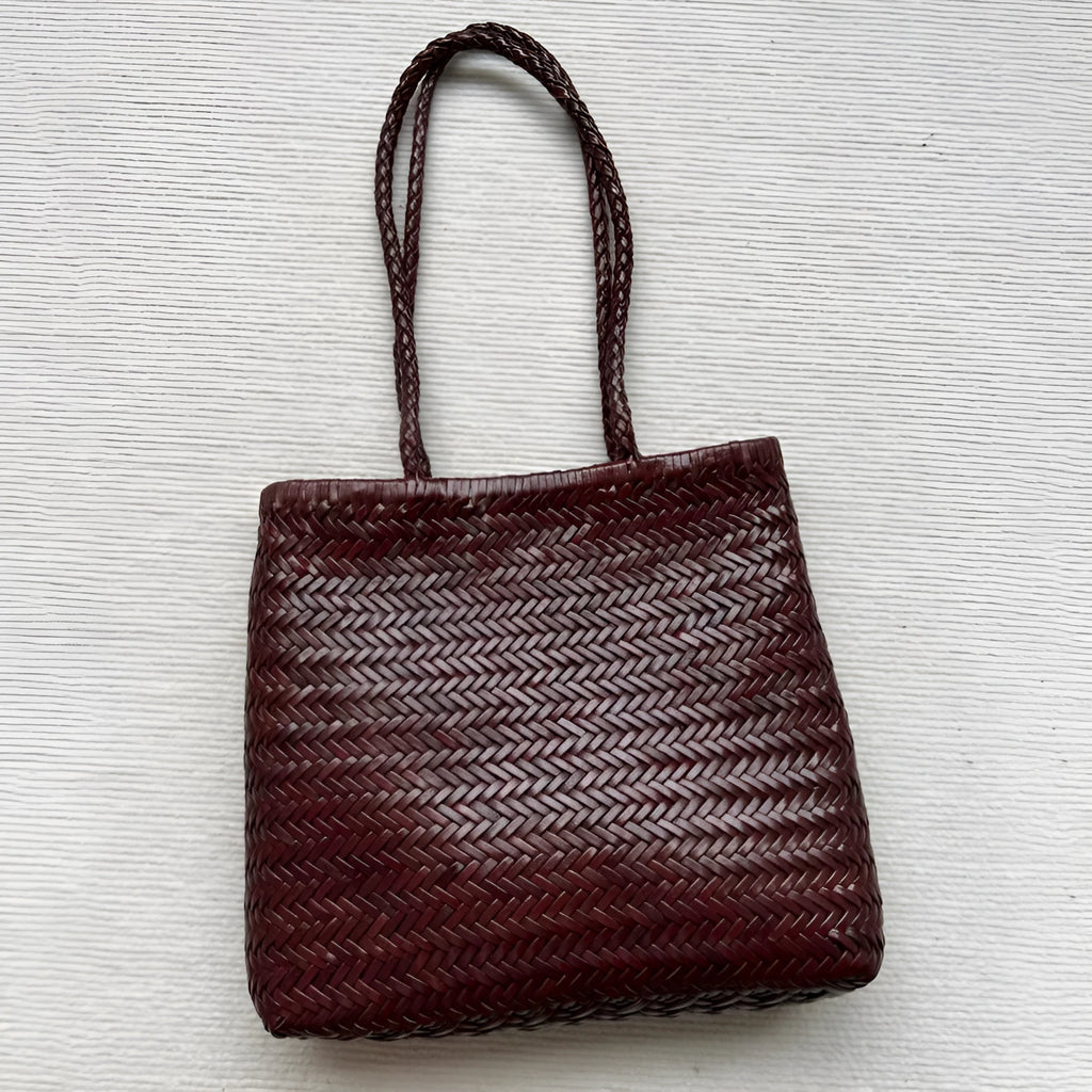 Handmade woven brown leather tote bag with three-dimensional pockets and vintage finish