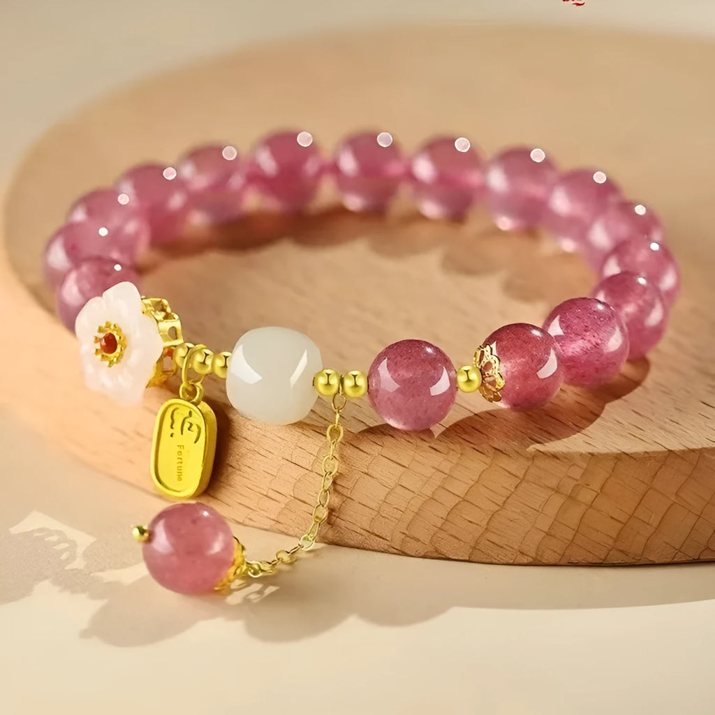 Handmade strawberry quartz crystal bracelet with a choice of moon, XINGX, or pearl charm on a natural crystal band.