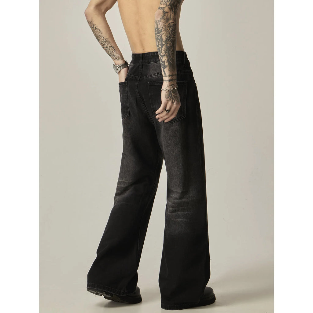 Black loose-fit straight leg denim jeans on a mannequin, showing the zip fly and retro style.